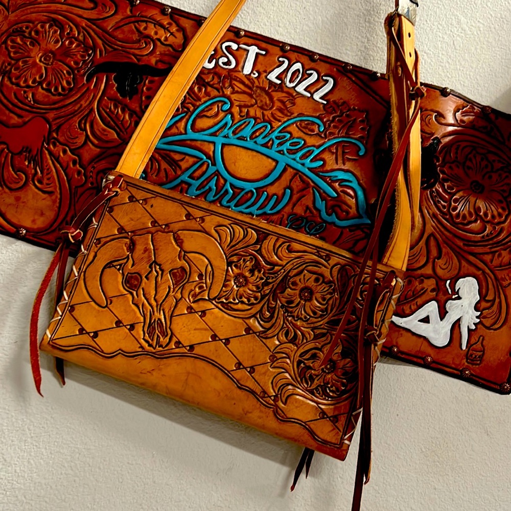 Handmade clutch purse with vintage buckle on cross body strap. All hand carved.